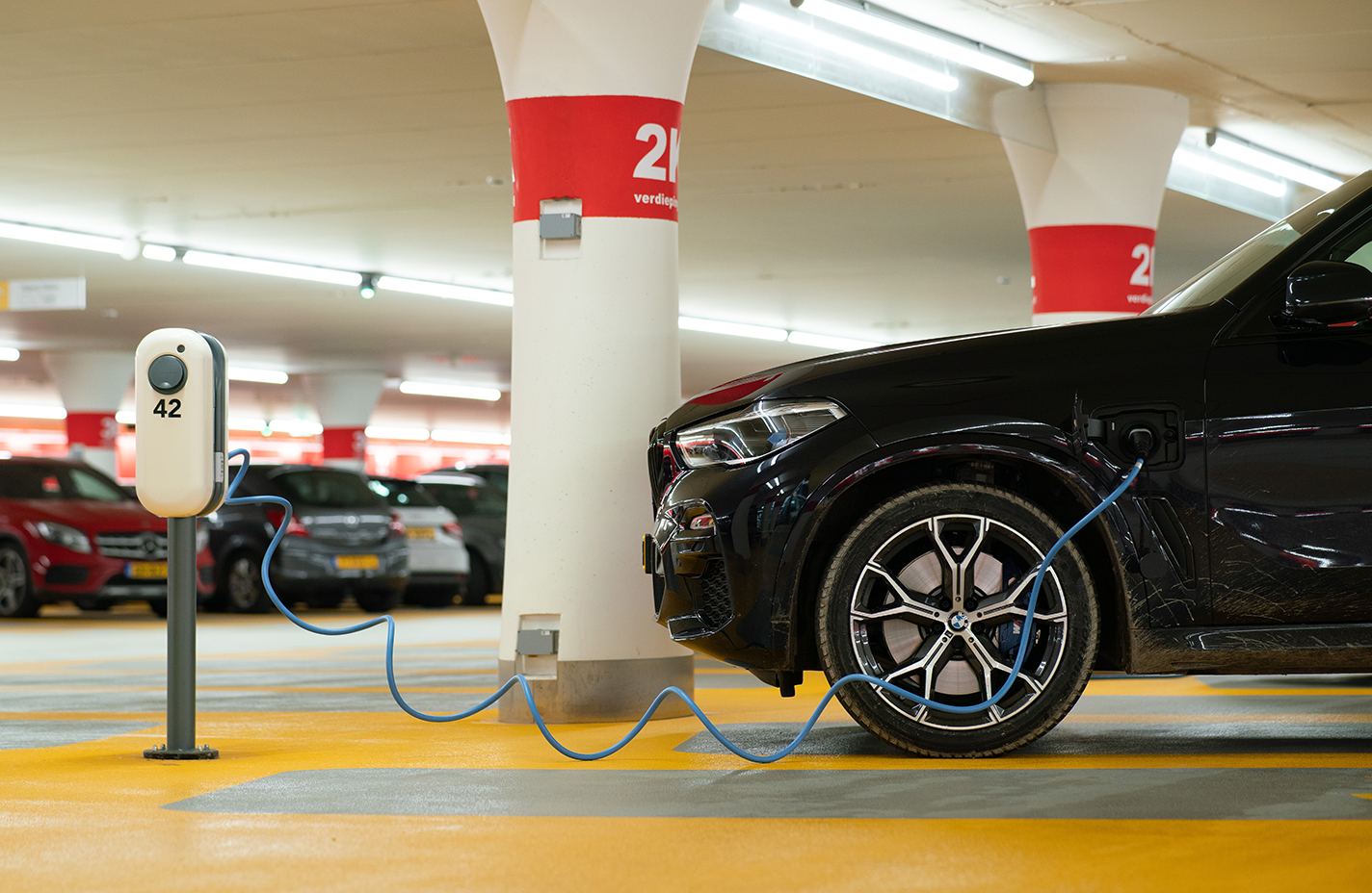 Electric car charging in a garage in the city